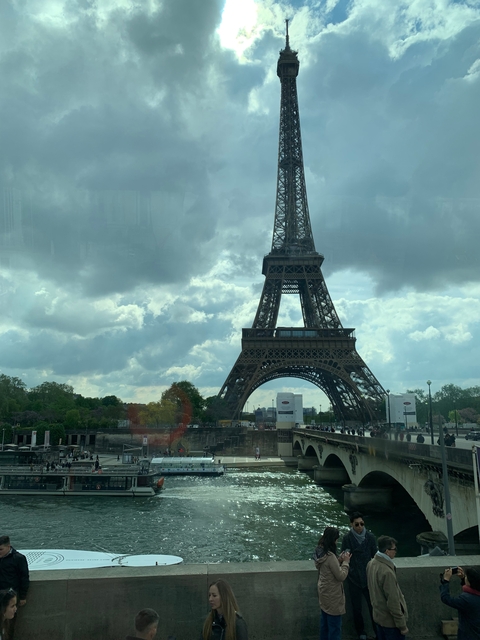The Eiffel Tower in Paris with cloudy sky.
