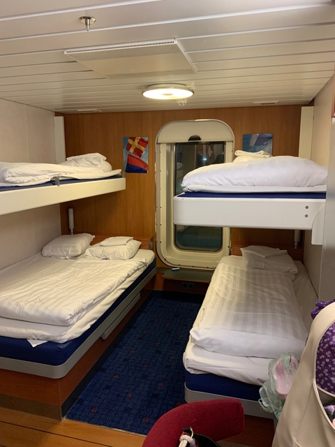       Interior of a compact bunk bed room in a ship.
  