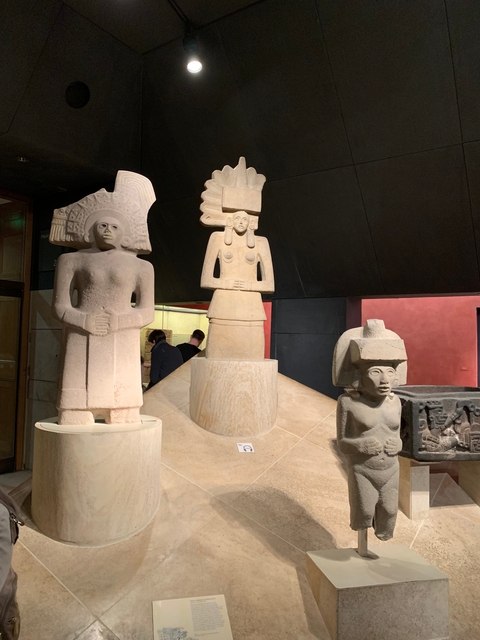       Ancient stone statues displayed in a museum.
  