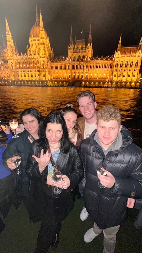 Group of people gathered outdoors at night.