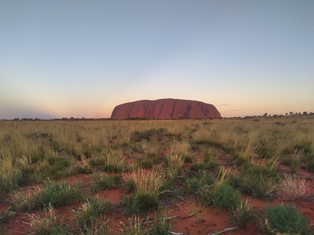 Uluru rock formation during sunset.