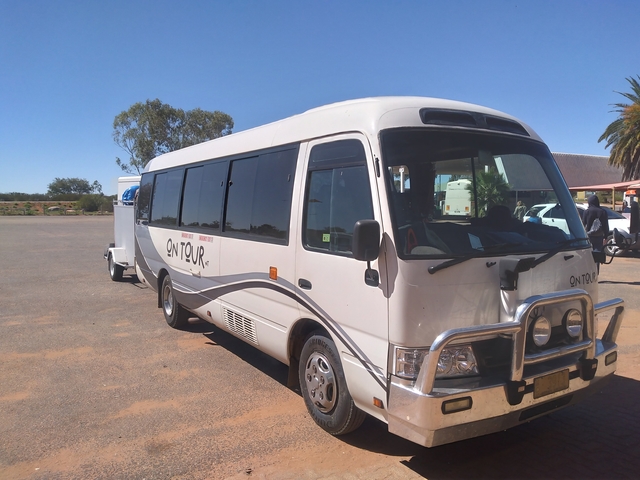 Tour bus parked in an open area.