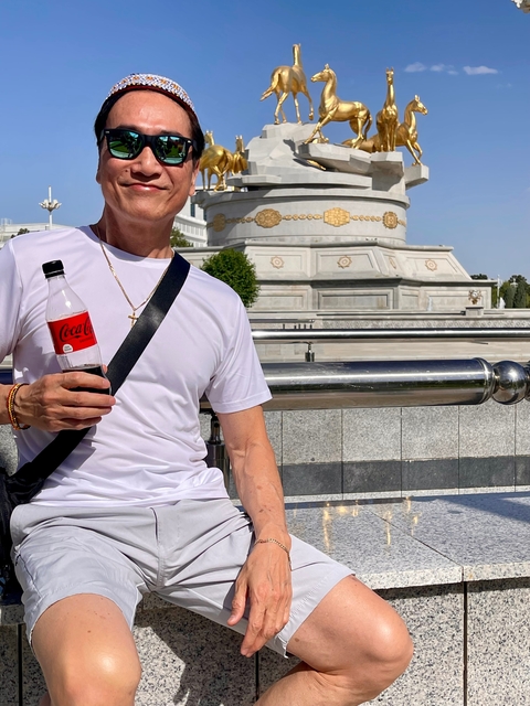       Close-up of a person holding a beverage bottle.
  