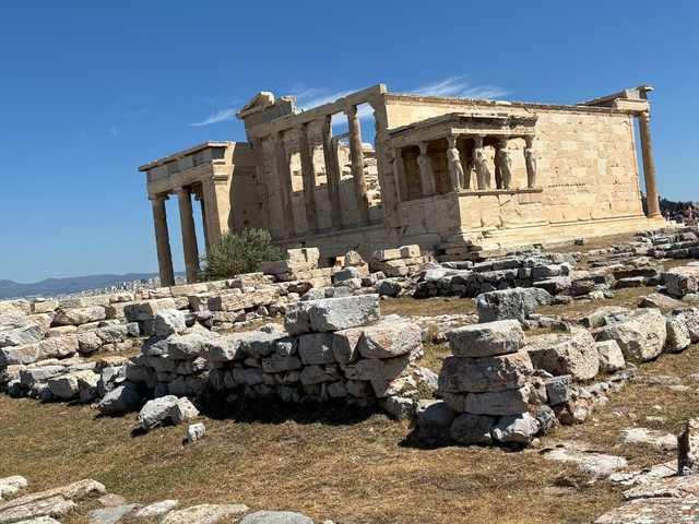       Ruins of an ancient temple with columns.
  