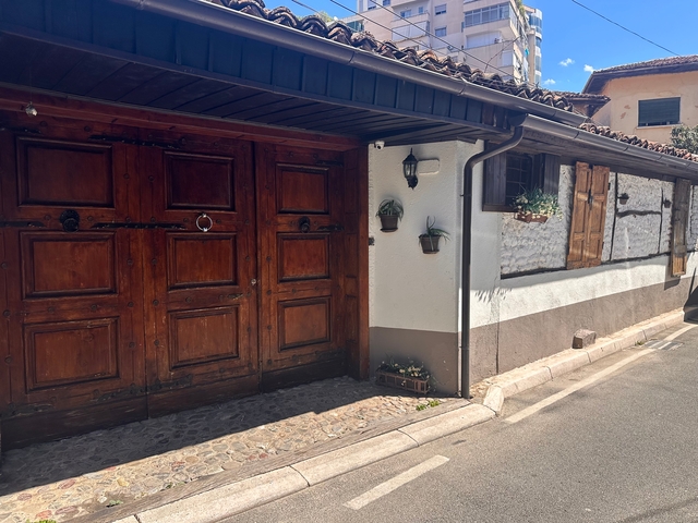 Old building with large wooden doors.