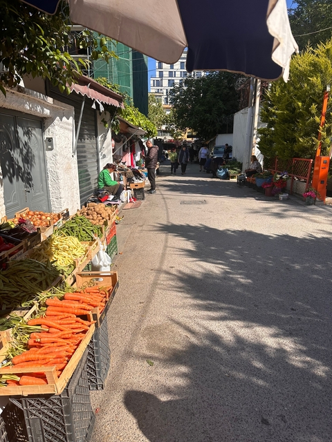 Street market scene with people and produce.