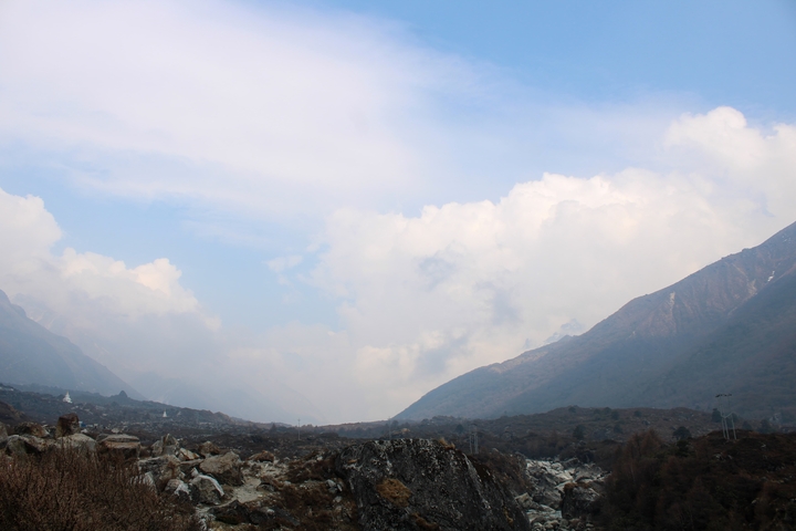 Valley with mountains and cloudy sky.