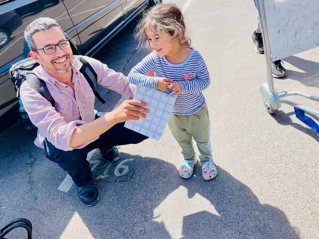Man with child holding a tile.