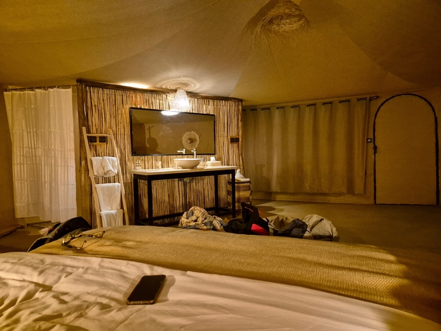       Interior of a luxury tent with elegant decor.
  