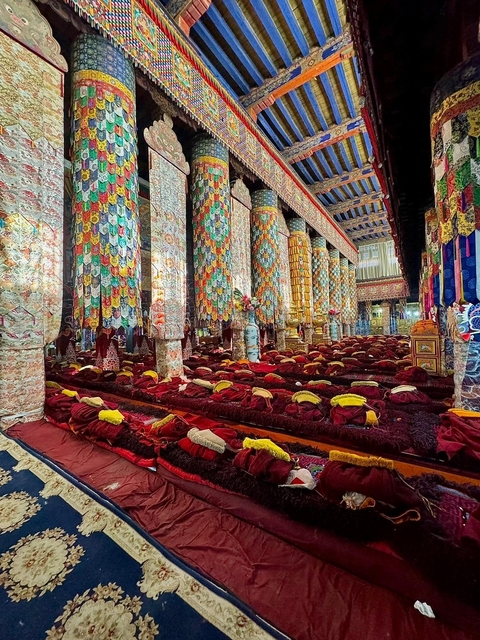 Interior of an elaborately decorated monastery with vibrant colors.
