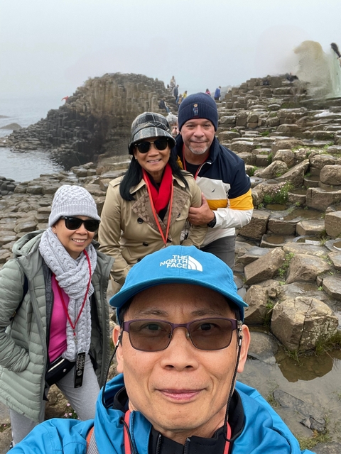Group of people posing on a rocky landscape.