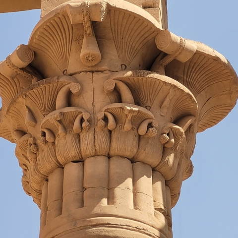       Close-up of an ancient Egyptian column with carvings.
  