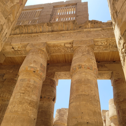 Ancient columns with hieroglyphics in Egyptian temple.