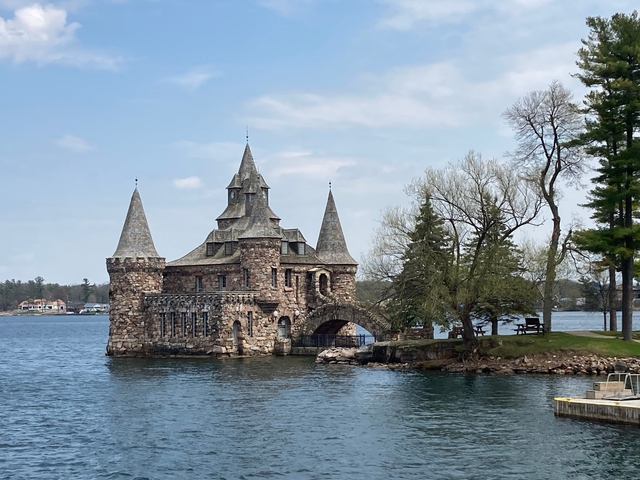 Castle-like building on a small island surrounded by water.