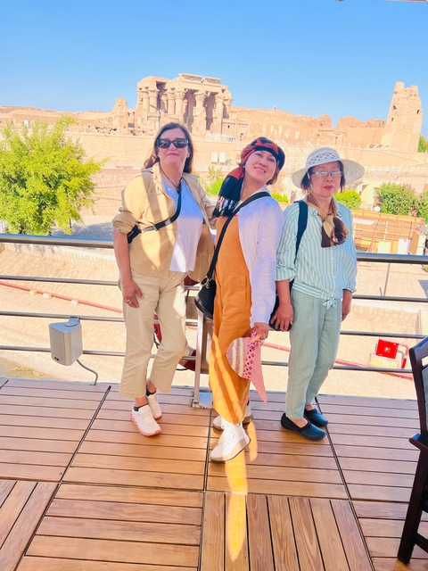 Three women posing on a ship deck.