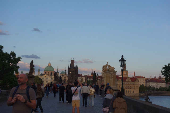 Charles Bridge in Prague crowded with pedestrians.