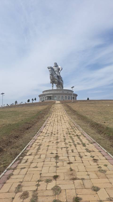       Giant horseman statue with a pathway leading to it.
  