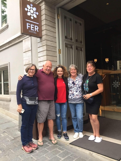 Small group standing together outside a building.