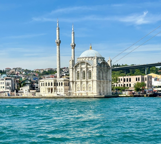       Ortaköy Mosque with a bridge in the background, located on the waterfront.
  