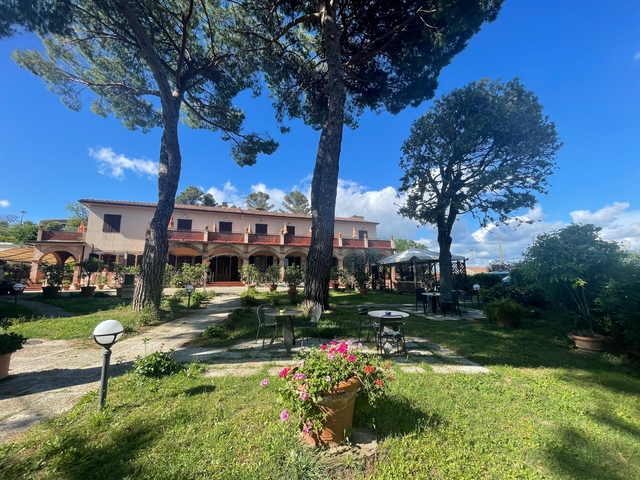 Charming villa with garden under clear blue sky.