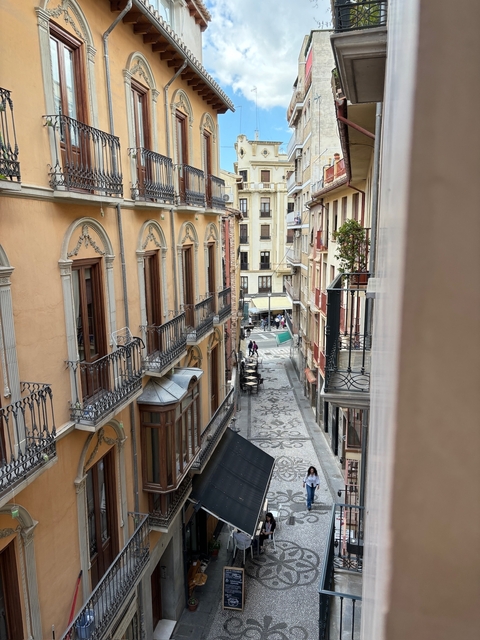       Street view from a high vantage point with balconies.
  