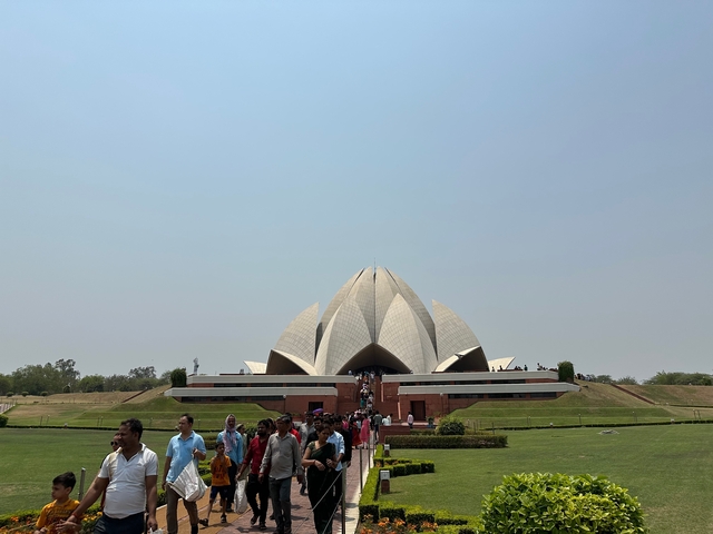       Lotus Temple with a crowd in front.
  