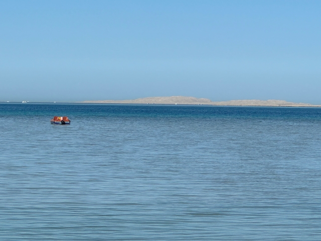       Calm ocean surface extending towards the horizon.
  