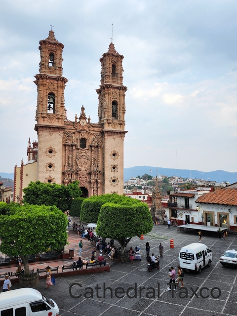 Ornate church surrounded by the town of Taxco.