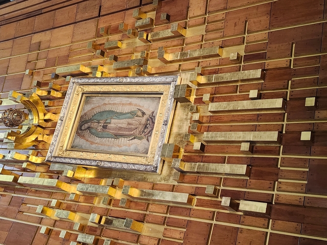       Iconic religious image displayed with intricate golden frame.
  