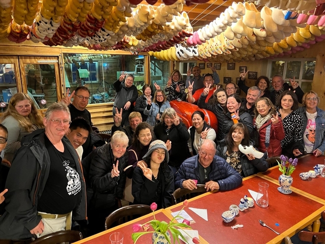 Group of people inside a cozy venue with wooden decor.