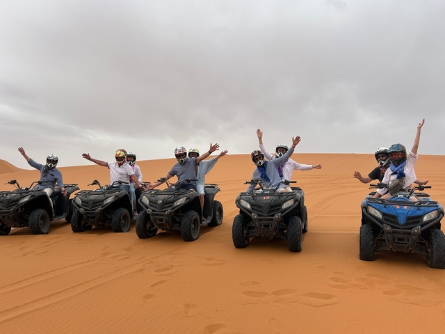 Group enjoying a quad bike adventure in the desert.