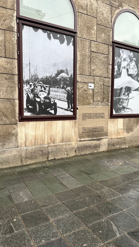 Stone wall with historical photos and plaques.