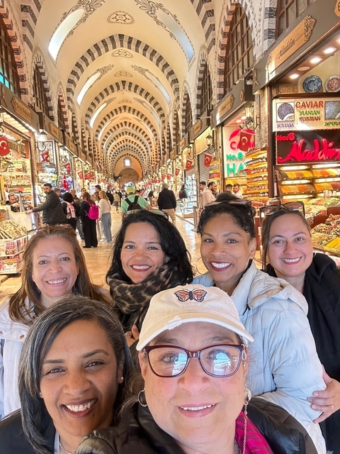       Group of women in a traditional market indoors.
  