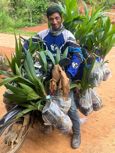 Man with potted plants on a scooter.