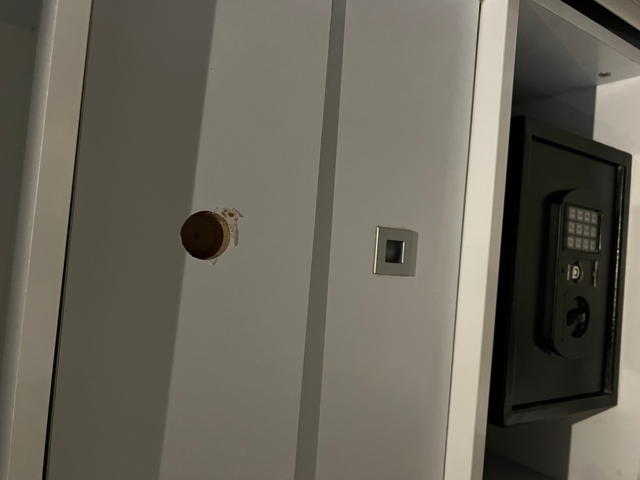       A wall with a broken part and a safe.
  