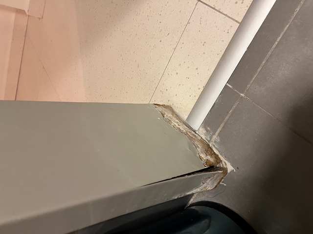       Floor corner with visible damage.
  