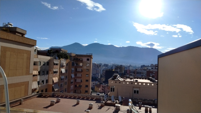 Cityscape with mountains in the background.