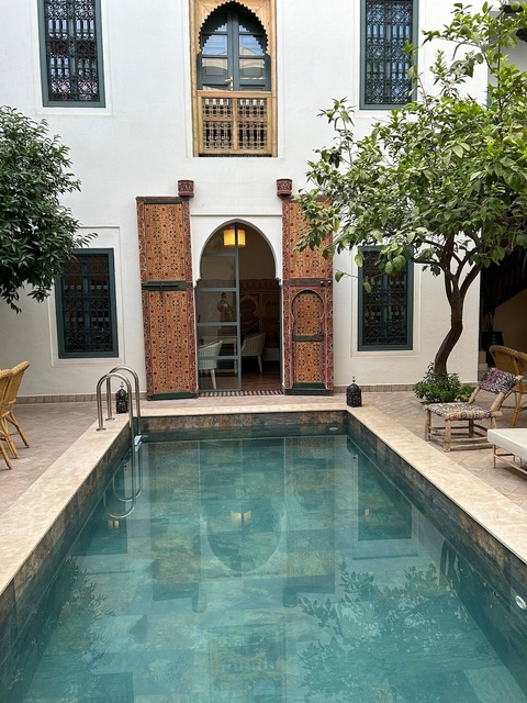       Courtyard with a small pool and trees.
  