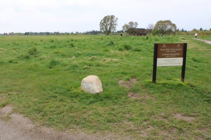       Culloden Battlefield sign beside a rock.
  