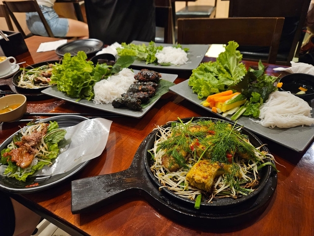 A spread of Vietnamese dishes on a dining table.