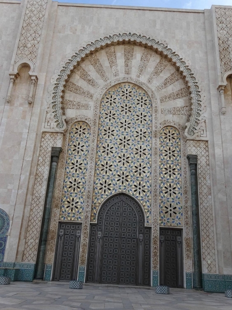 Close-up of intricate mosaic on a large gate.
