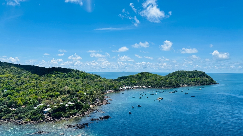       Scenic view of a coastal landscape with the sea and hills.
  