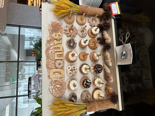 Display of various donuts with decorations.