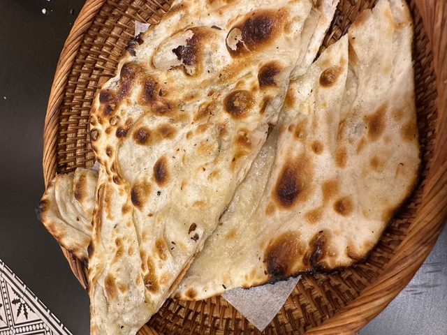       Close-up of baked flatbreads in a basket.
  