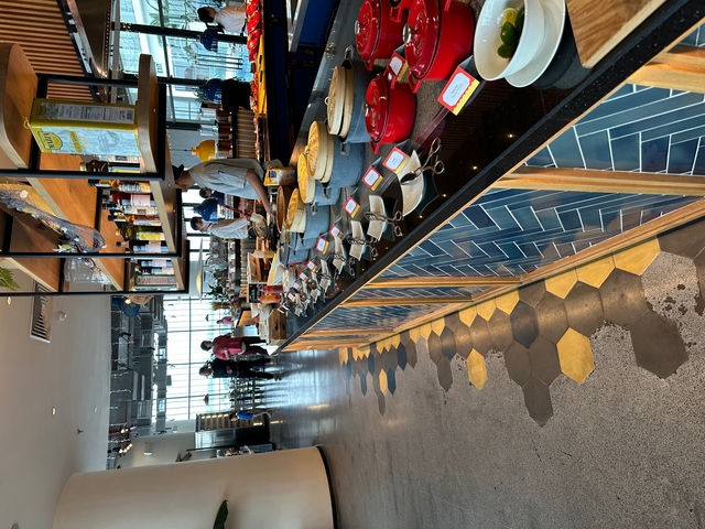       Restaurant interior with dining tables and food display.
  