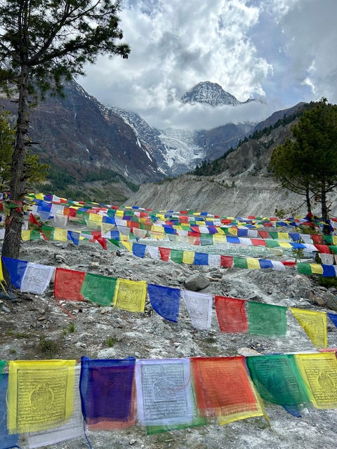Colorful prayer flags along a rocky path in the mountains
