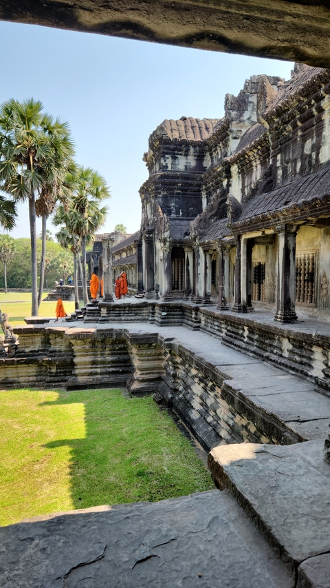 Monks walking through ancient temple ruins.