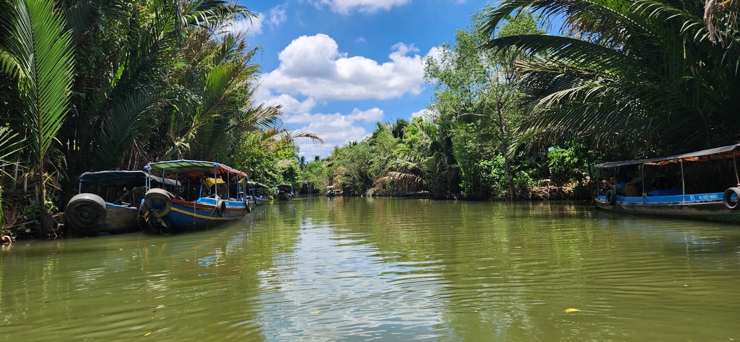 Boats on a river surrounded by lush greenery.