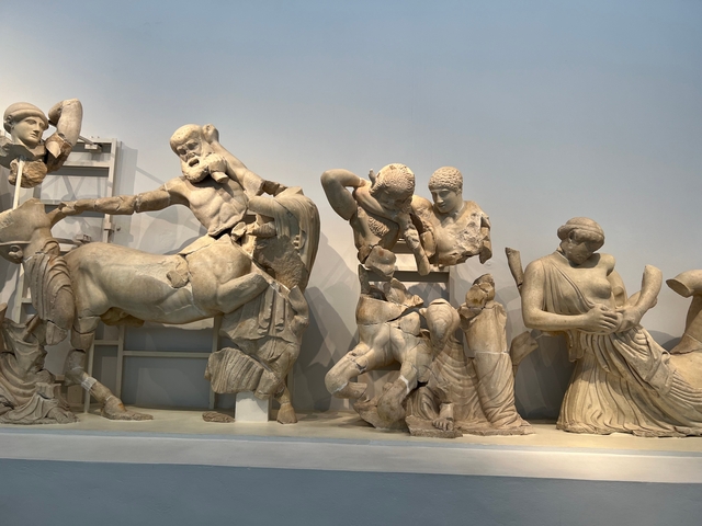 Ancient sculptures in a museum setting.