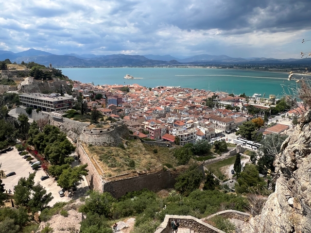 Scenic coastal town with sea and mountains.